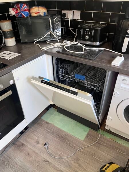 Installed integrated dishwasher under kitchen worktop