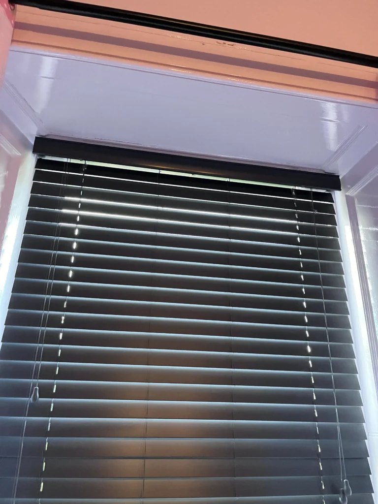 Day and night blind installed in bedroom window recess.