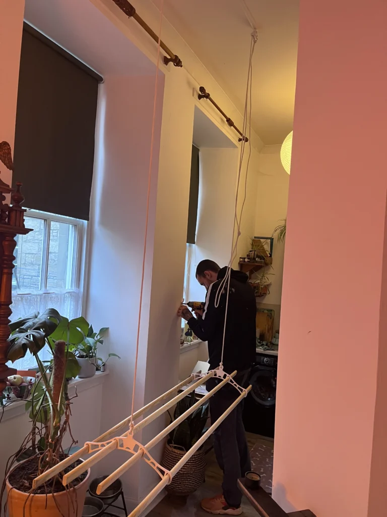 Wooden ceiling clothes airer pulley system installed in kitchen.