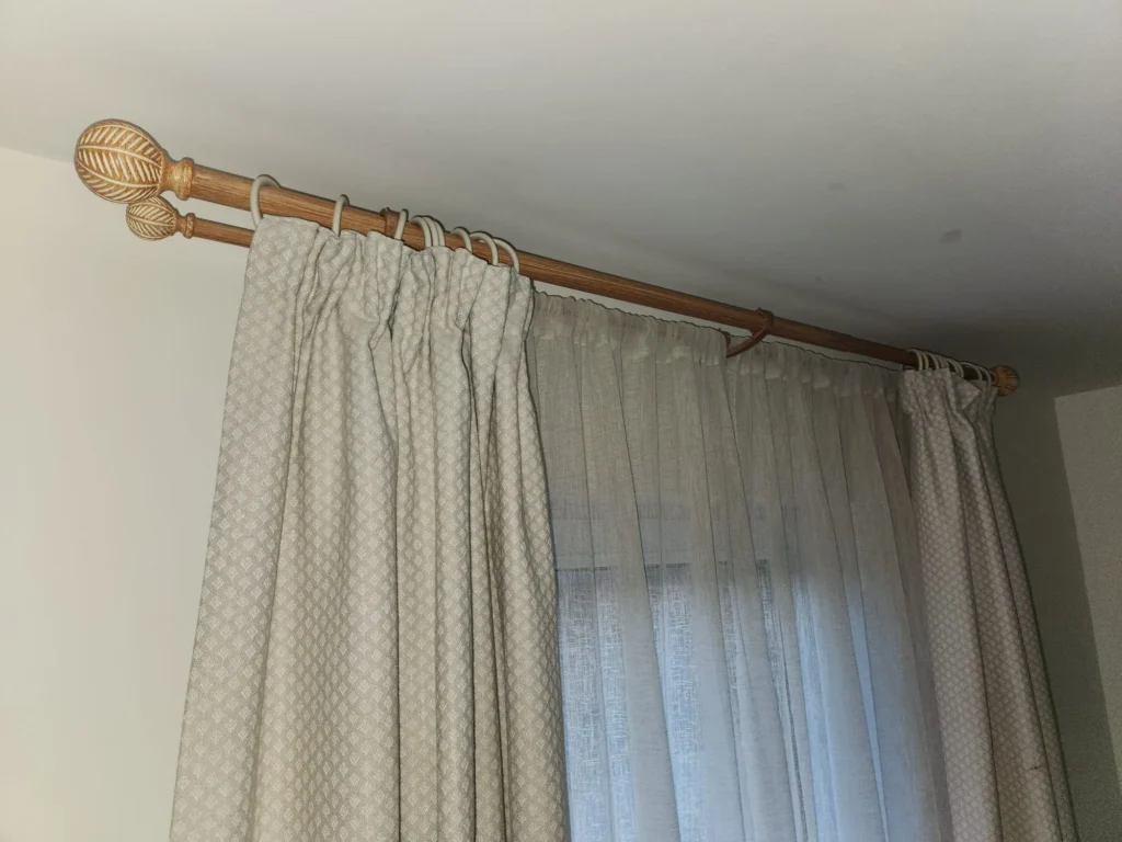 Double curtain pole installation on a plasterboard wall in Govan